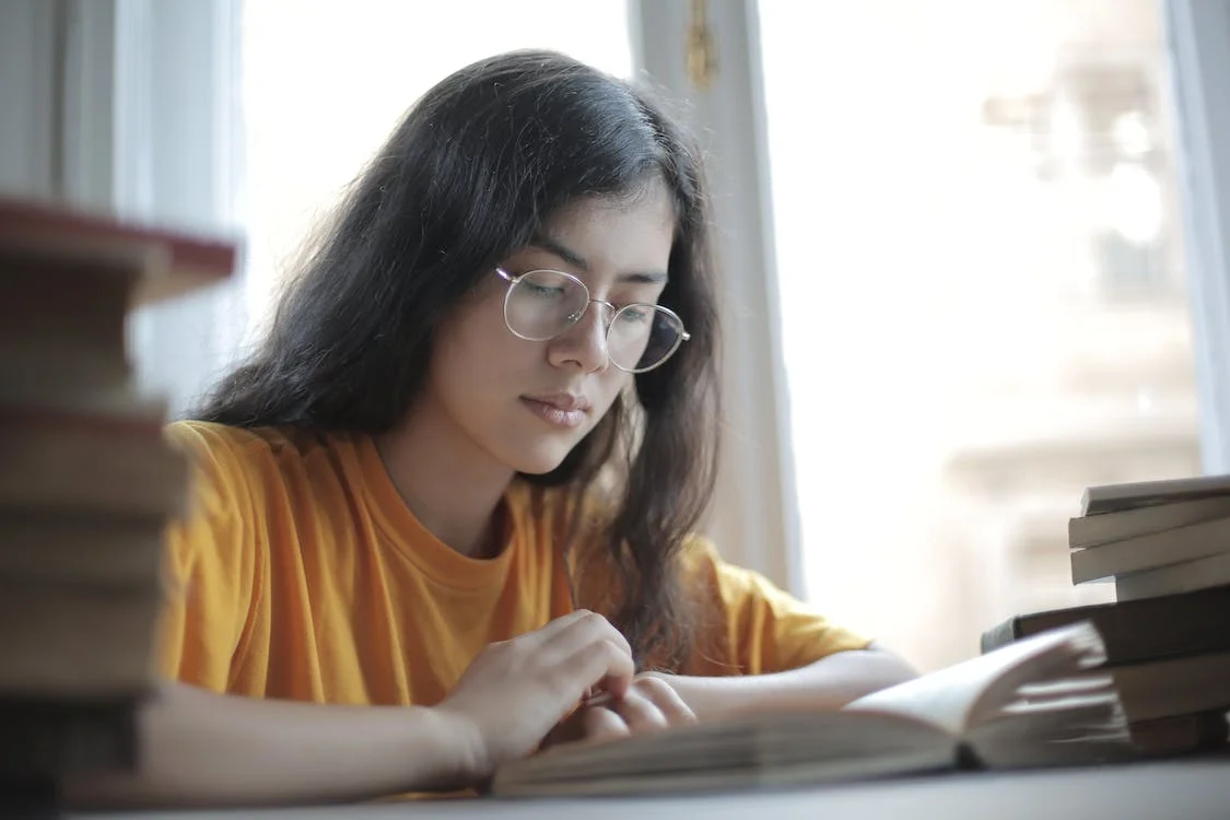 A young woman preparing for her IELTS exam by following the tips on this blog.